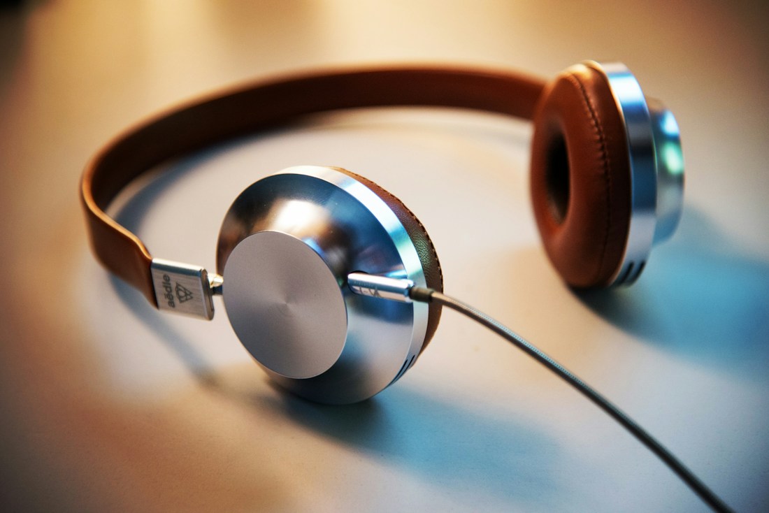 Over-ear headphones on a desk — lifestyle stock photograph